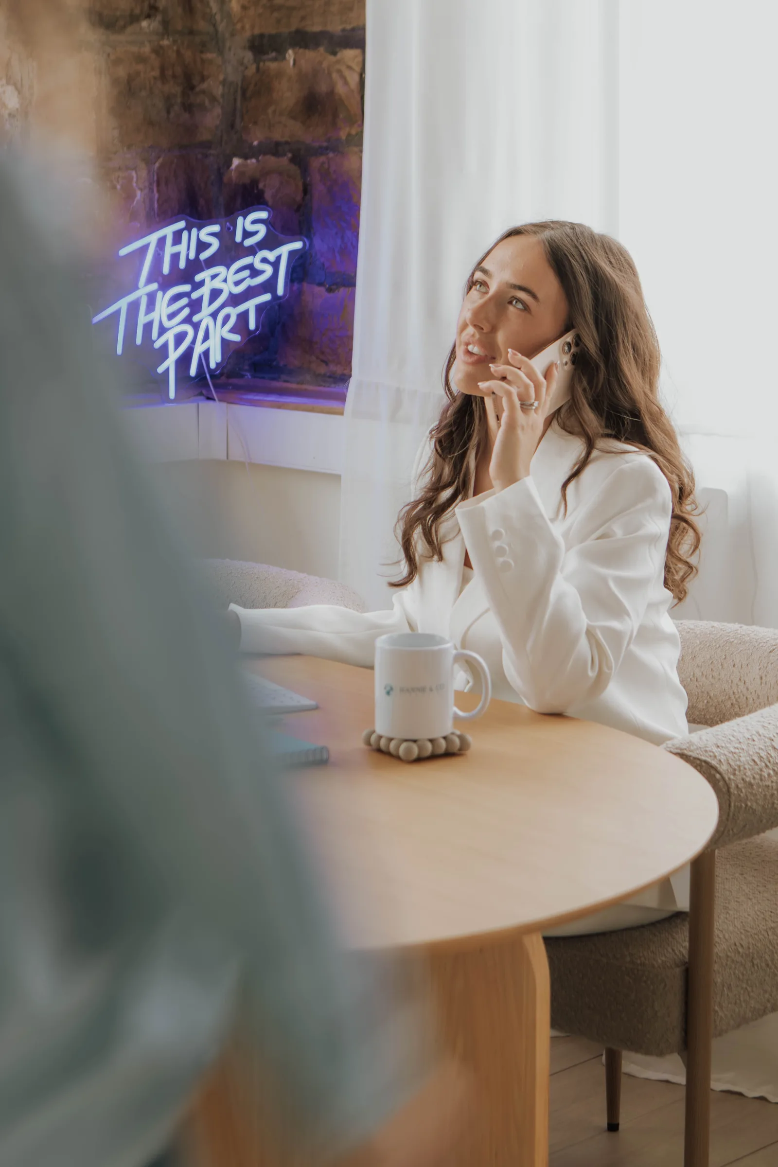 Hannie at her desk, on the phone with a client